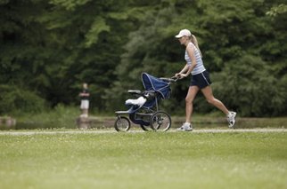Mom jogging with baby stroller.