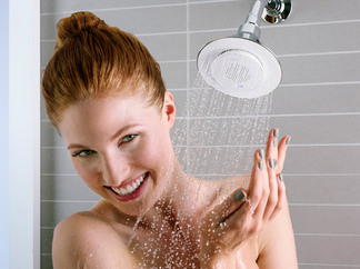 Woman showering with Kohler Moxie