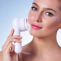 Woman using clarisonic Mia Smart skin cleansing system.